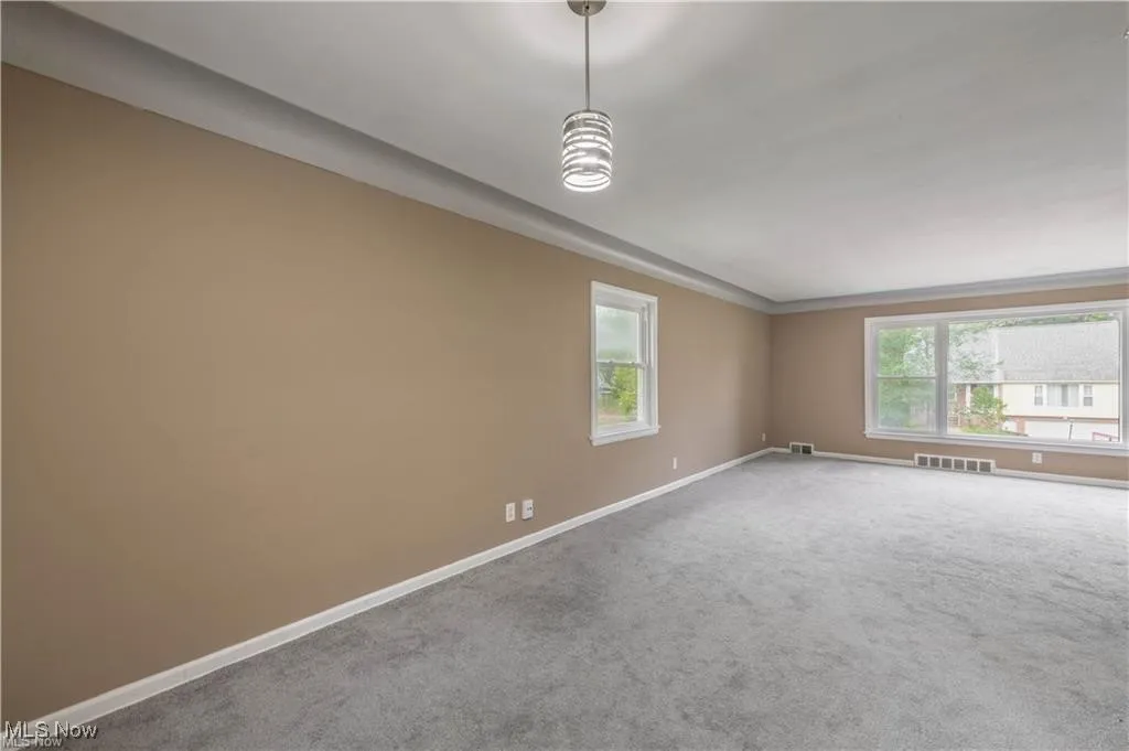 Unfurnished room with carpet and baseboards
