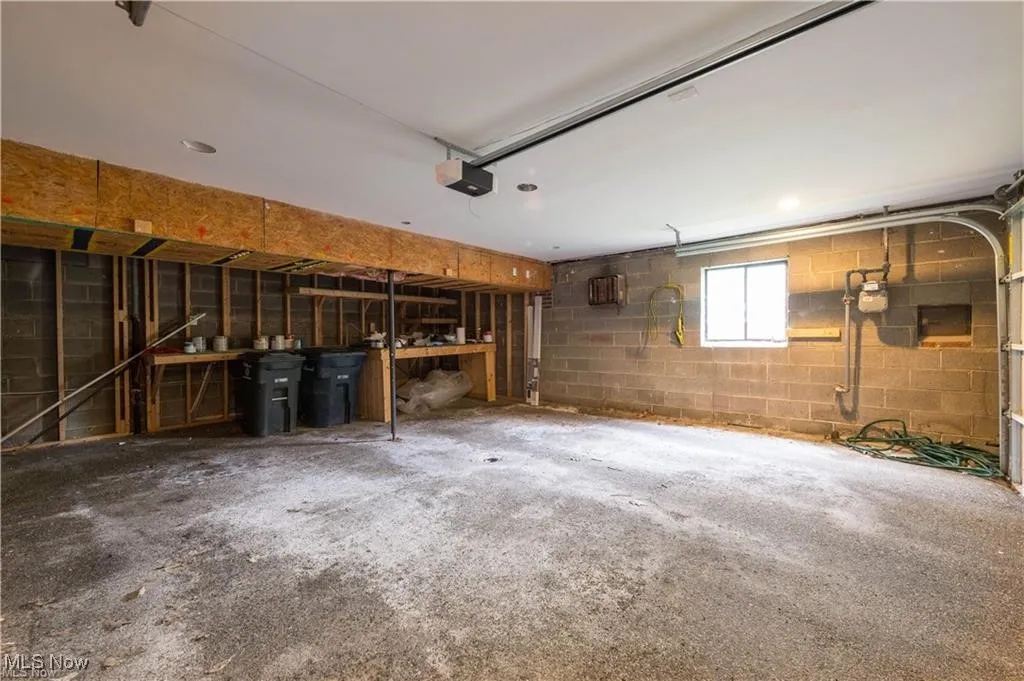 Garage with concrete block wall and a garage door opener