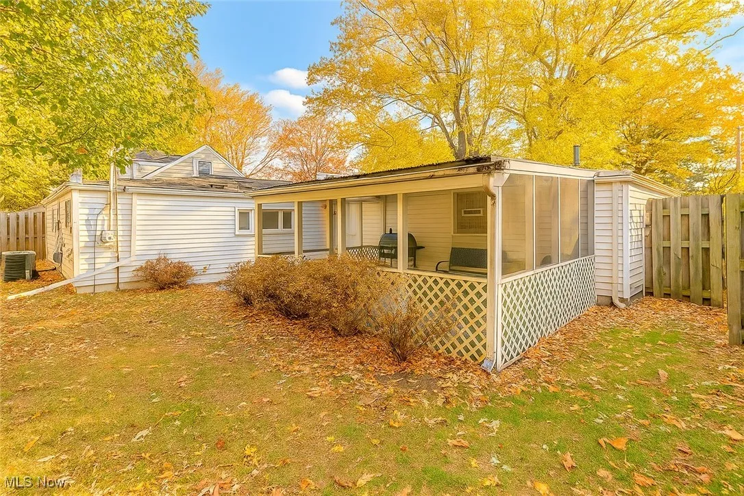 Rear view of house with a sunroom