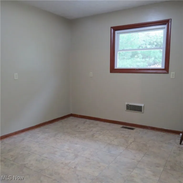 Unfurnished room with baseboards