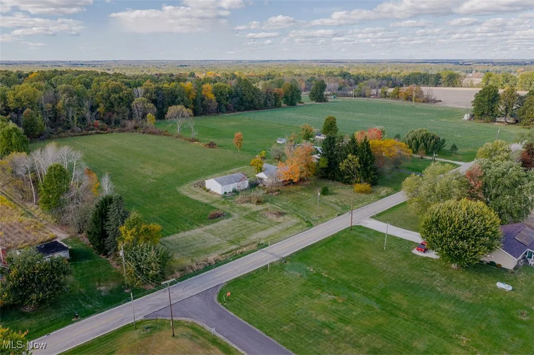 Aerial view of property and surrounding area featuring rural landscape