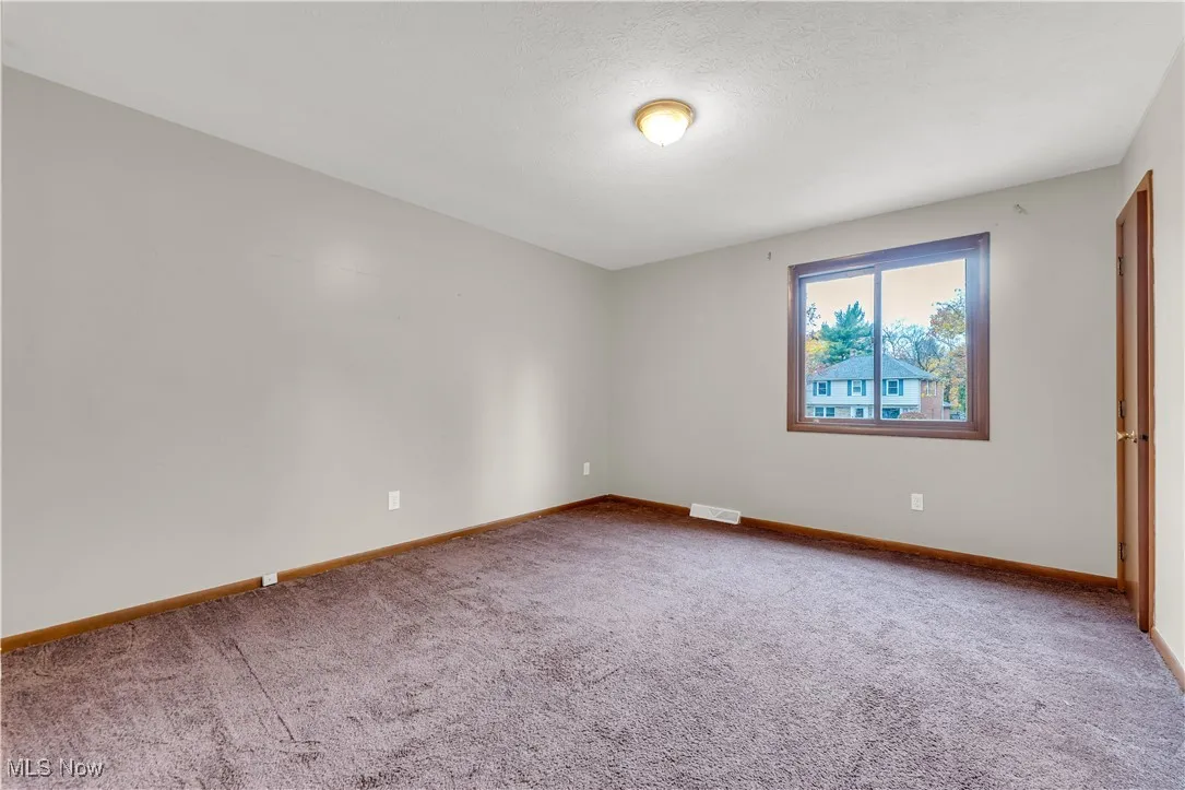 Empty room featuring carpet floors and a textured ceiling