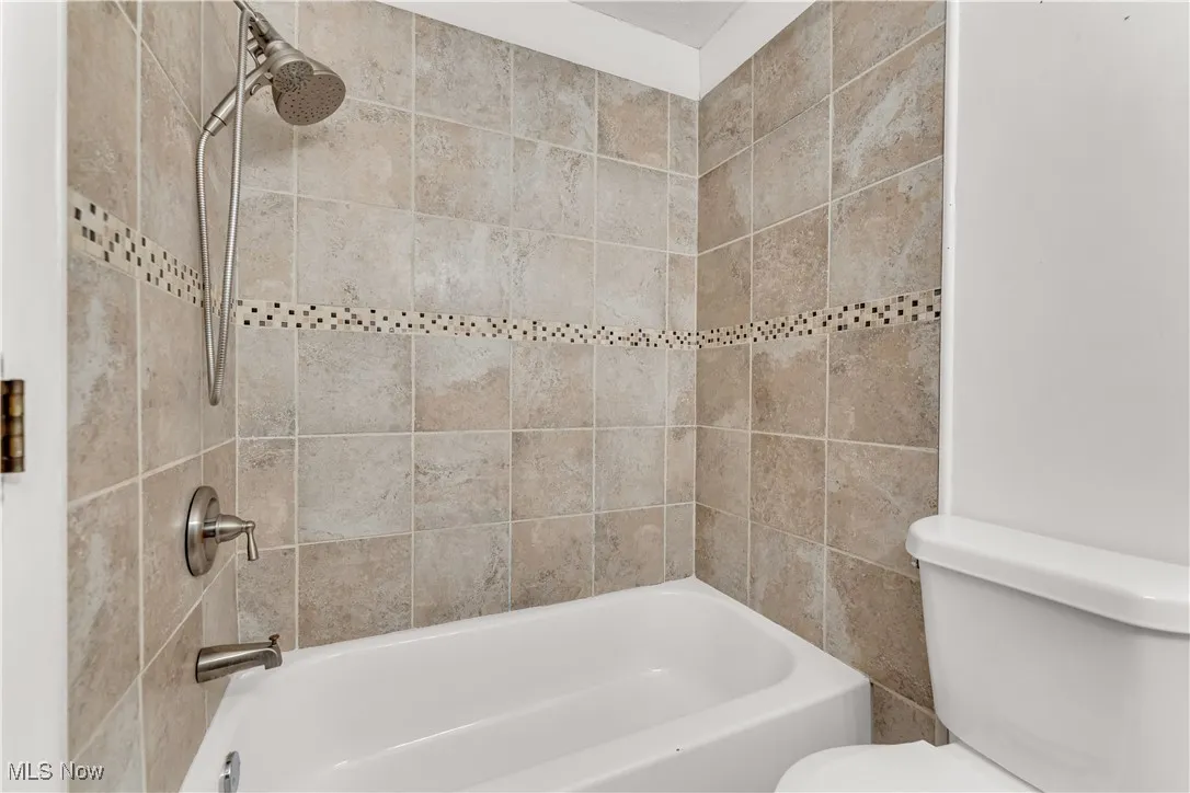 Full bath with shower / bath combination and toilet