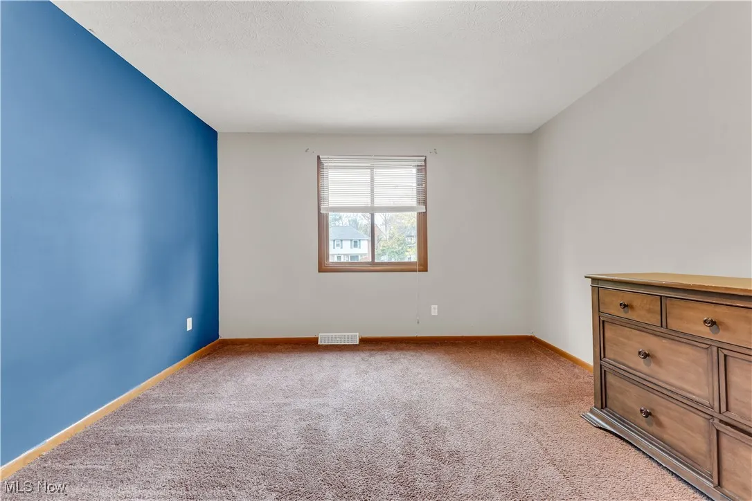 Unfurnished room featuring light colored carpet and a textured​​‌​​​​‌​​‌‌​‌‌​​​‌‌​‌​‌​‌​​​‌​​ ceiling