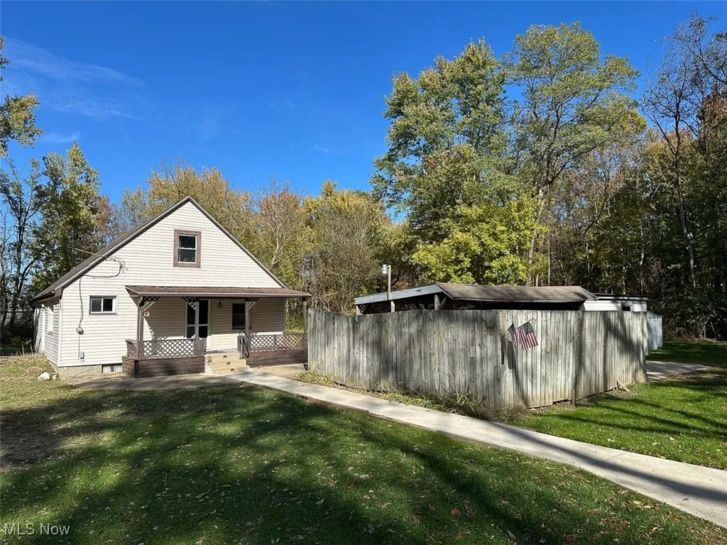 front of house featuring a yard and covered porch