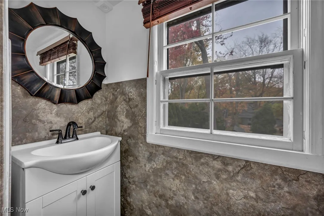 Bathroom with vanity and backsplash