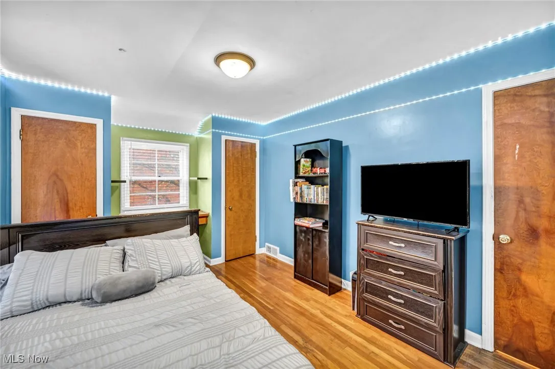 Bedroom featuring light wood-type flooring and baseboards