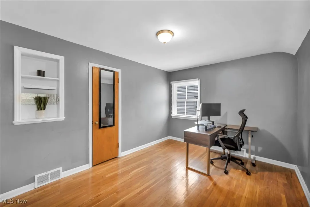 Office featuring light wood-style floors and baseboards