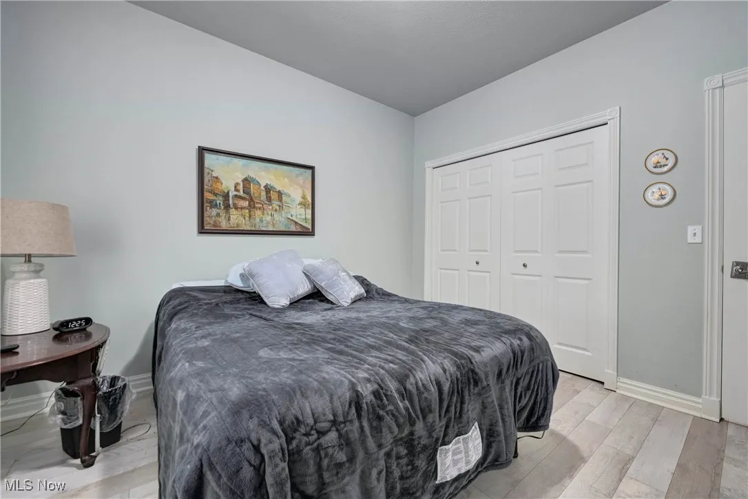 Bedroom featuring light wood-style flooring and a closet