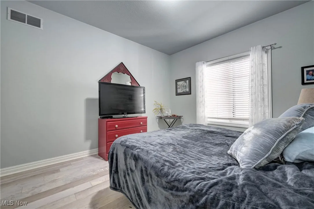 Bedroom featuring light wood-type flooring and baseboards