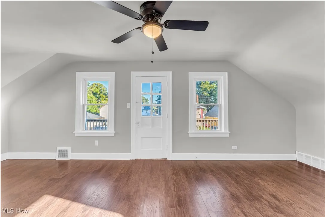 Bonus room featuring vaulted ceiling and dark wood finished floors