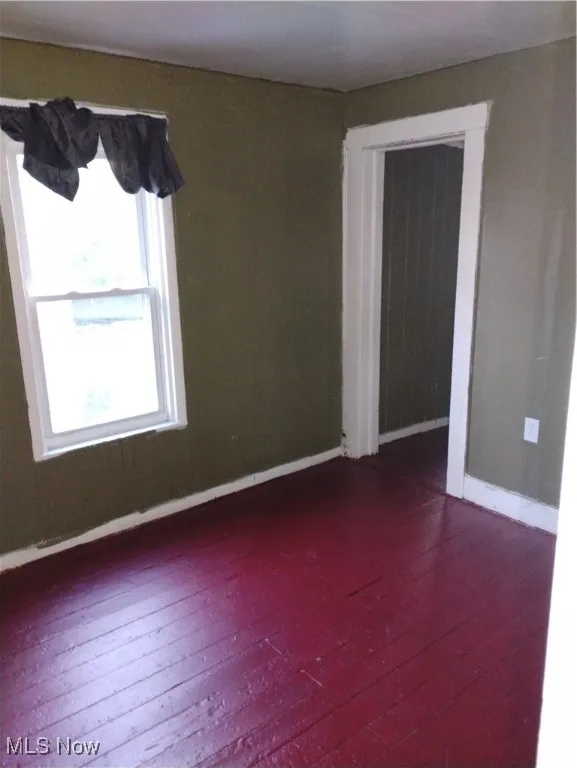 Unfurnished room with dark wood-style floors
