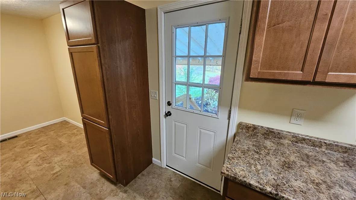 Kitchen door opens to the covered rear patio