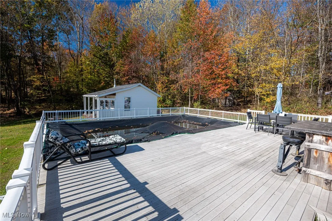 Wooden terrace with outdoor dining area and grilling area