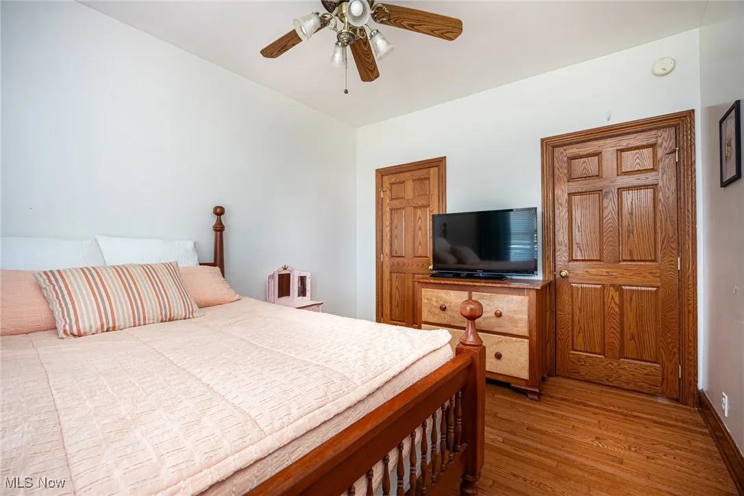 Bedroom featuring wood finished floors and a ceiling fan