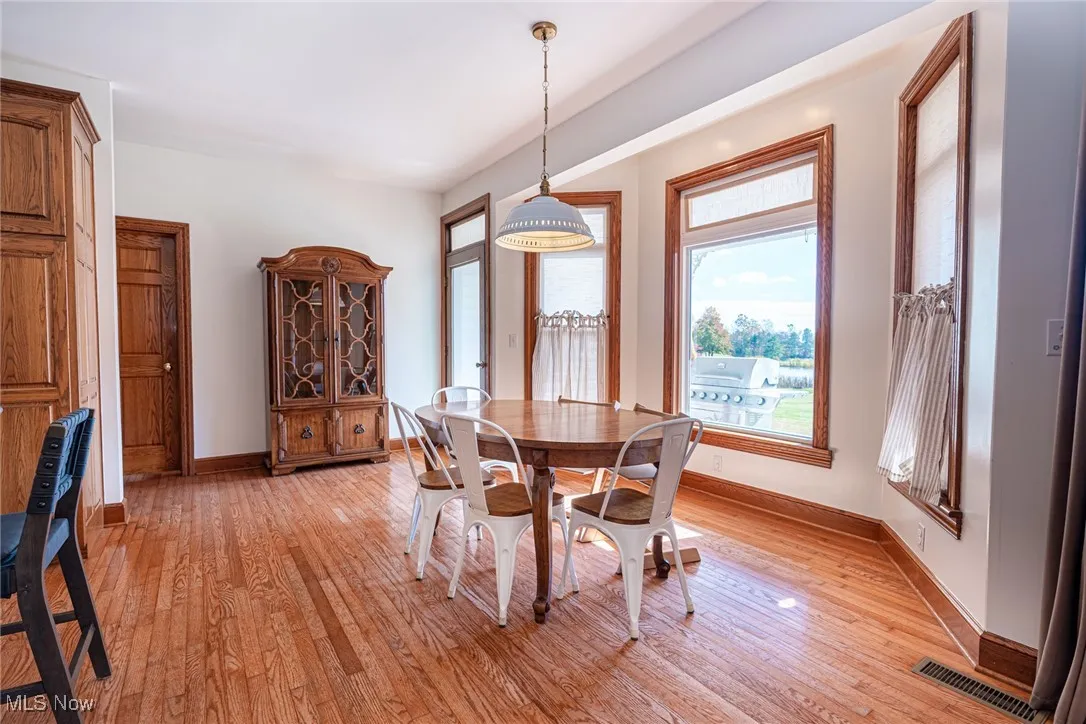 Dining space with light wood finished floors and baseboards