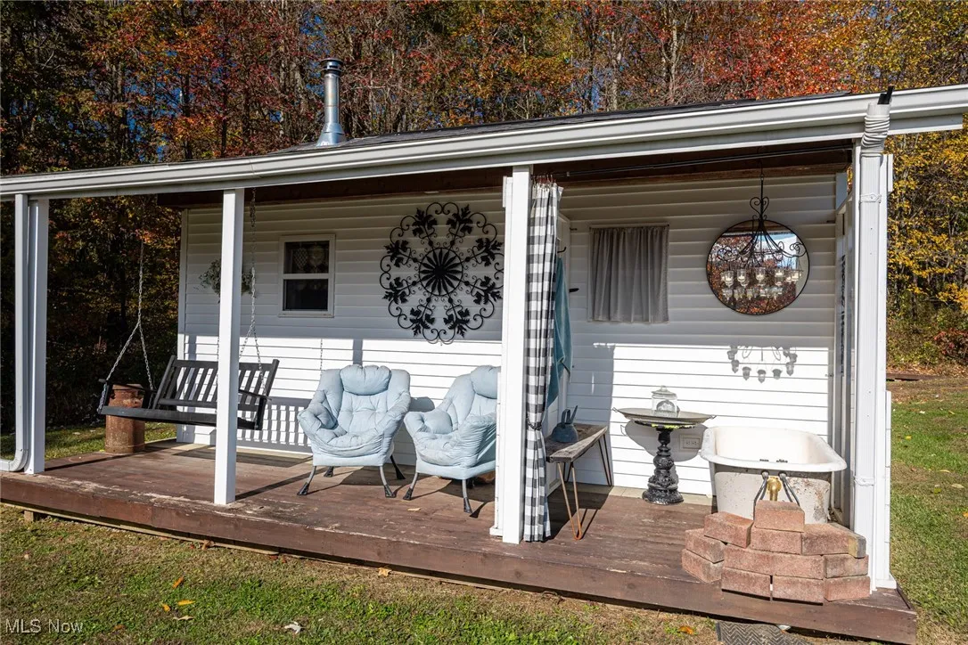 Porch featuring a grill