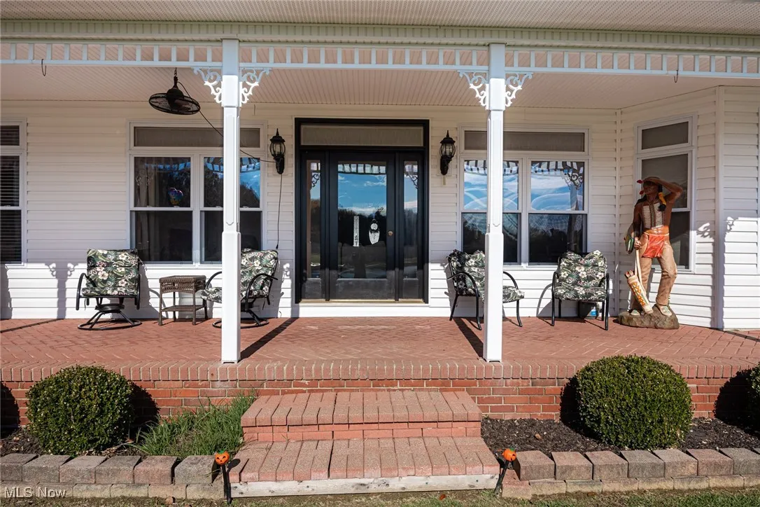 Doorway to property with covered porch