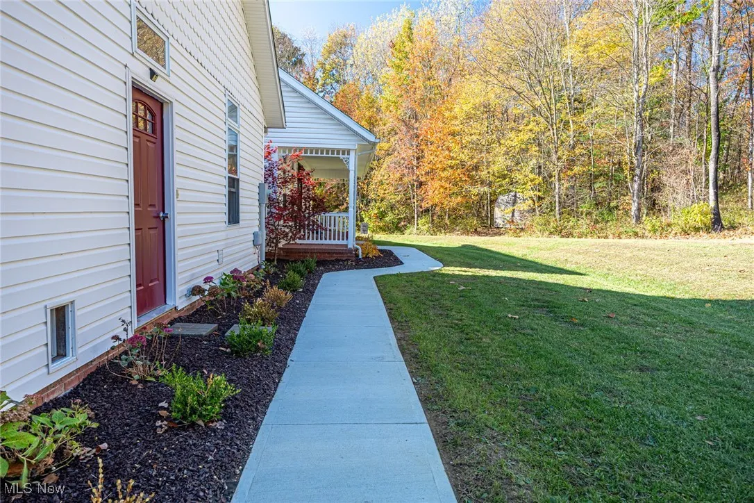 View of green lawn with a porch
