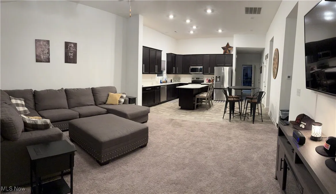 Living room featuring light carpet and recessed lighting