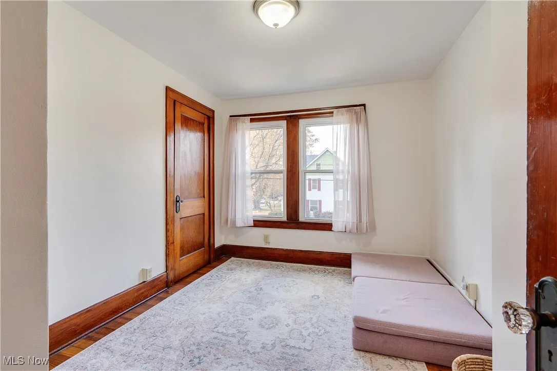 Bedroom featuring wood finished floors and baseboards
