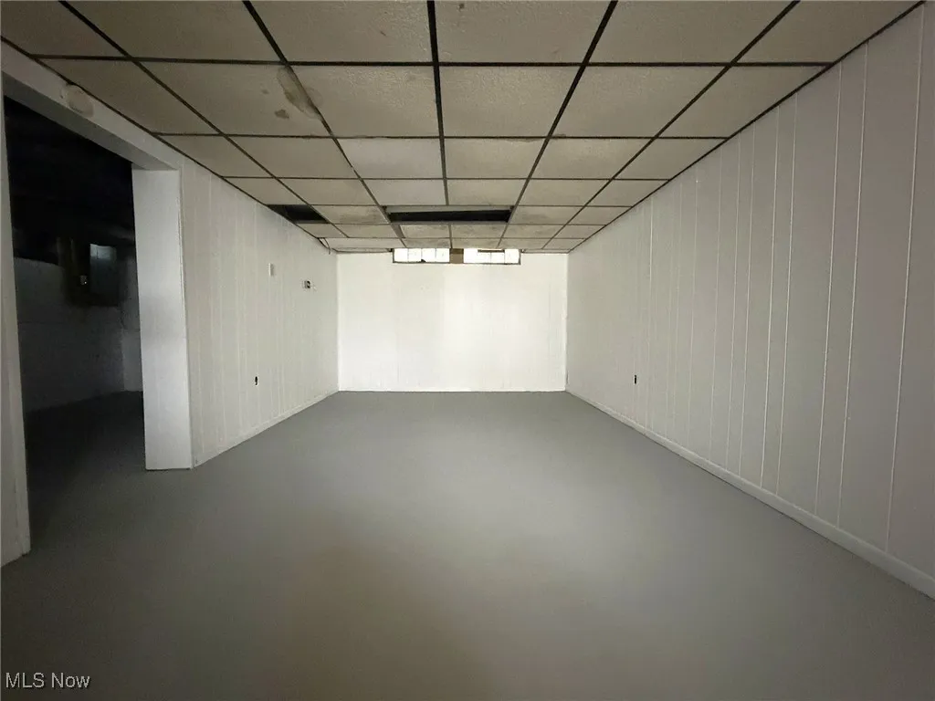 Finished basement featuring a drop ceiling