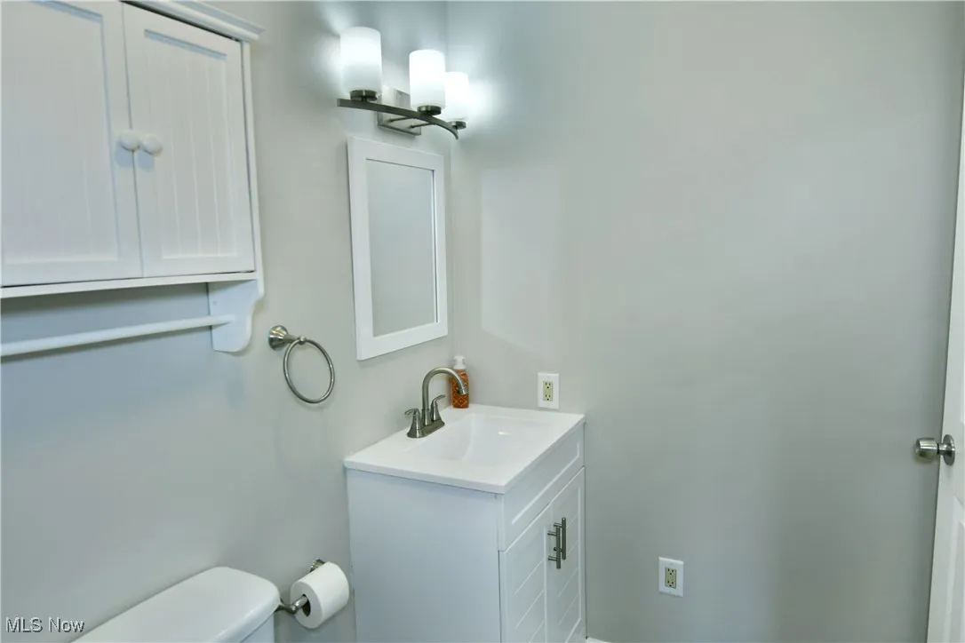 Half bath featuring toilet and vanity