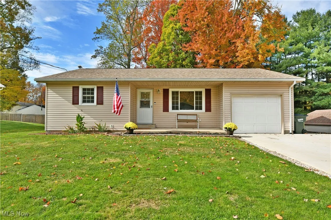 Single story home with covered porch, concrete driveway, an attached garage, and roof with shingles