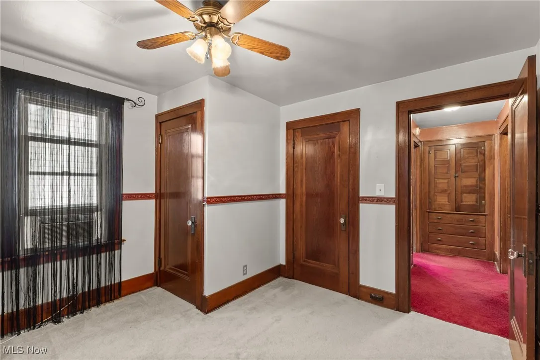 Unfurnished bedroom with a closet, carpet floors, and ceiling fan