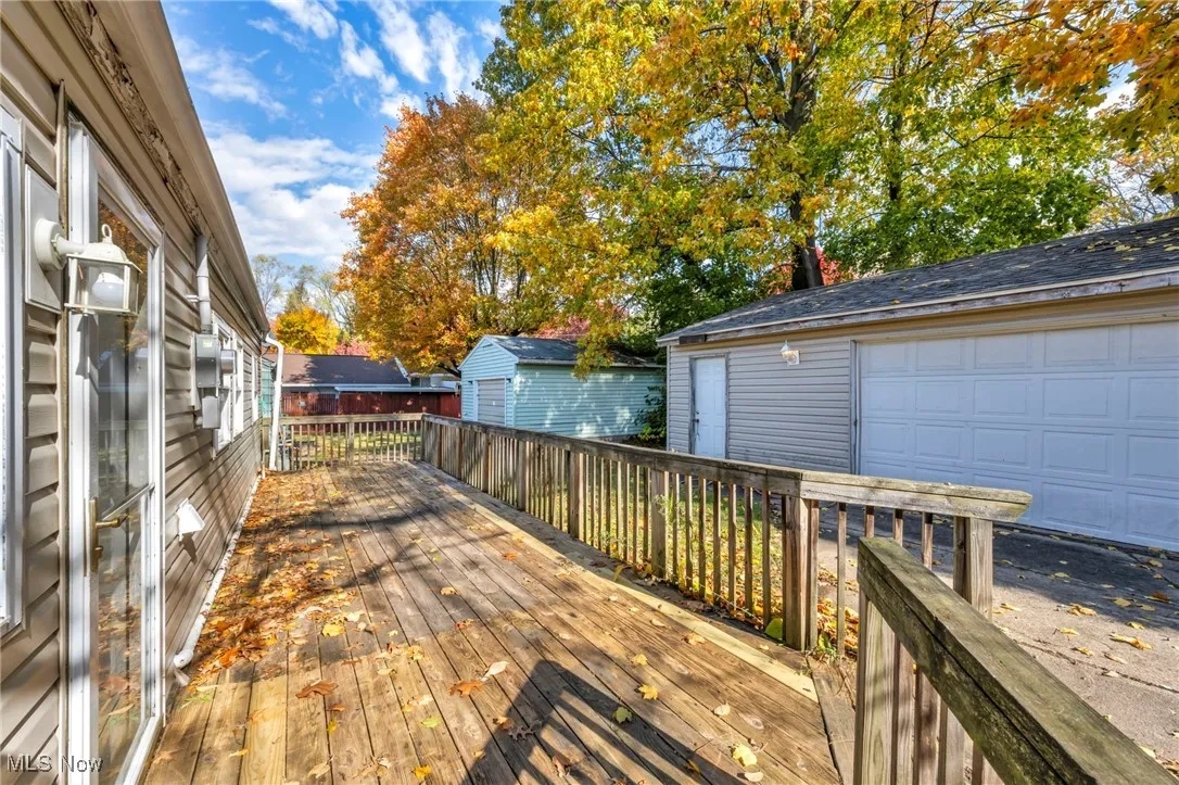 Wooden terrace with an outbuilding and a garage