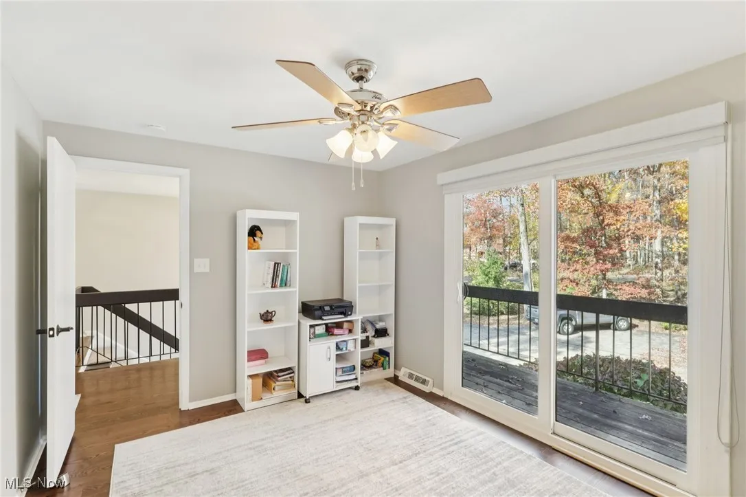 Game room with wood finished floors and ceiling fan