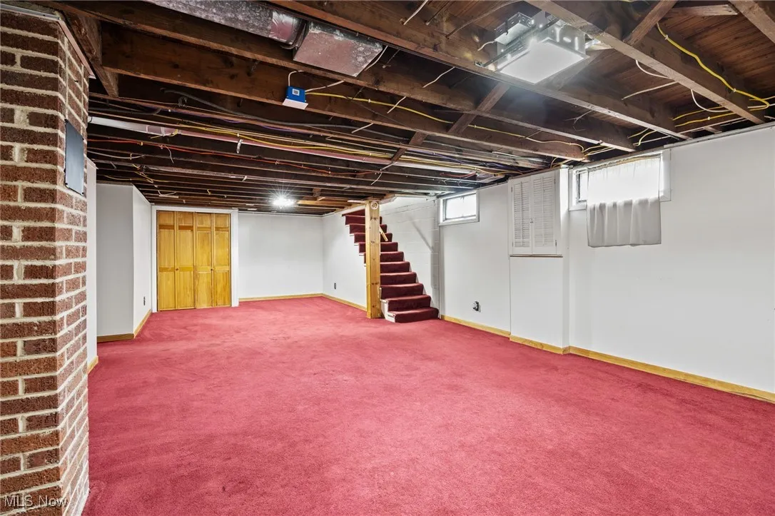 Below grade area featuring stairway and carpet floors