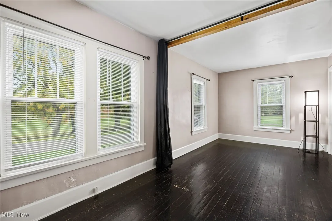 Empty room featuring dark wood-style flooring