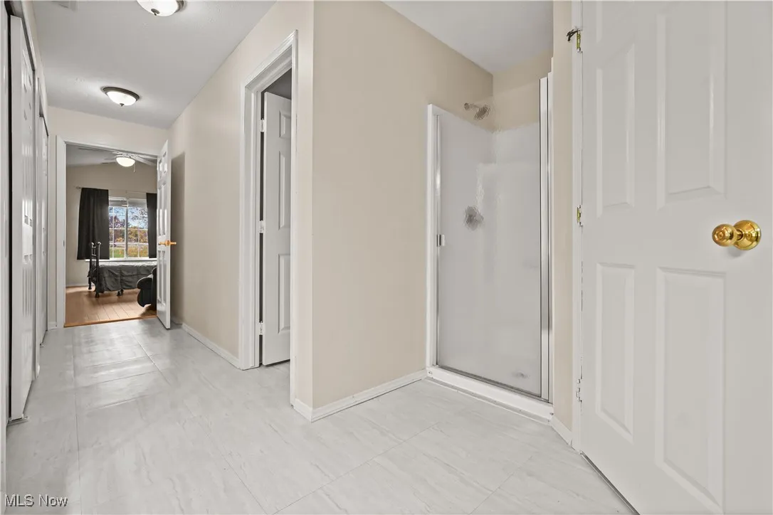 Corridor featuring baseboards and light tile patterned floors