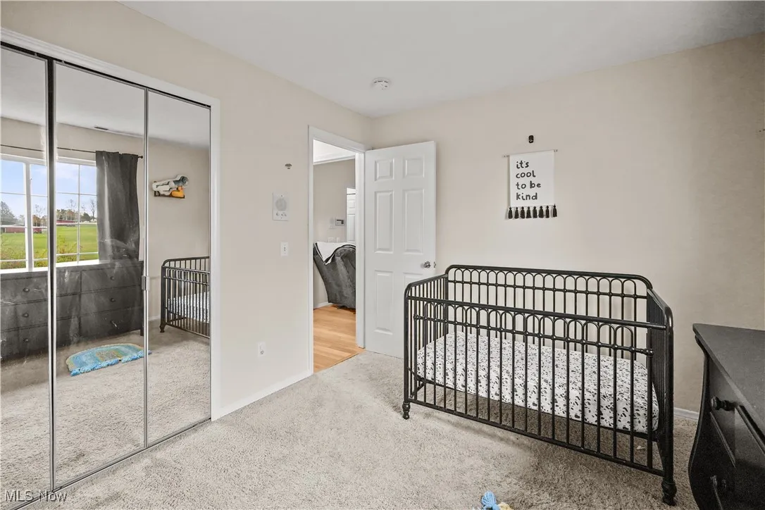 Carpeted bedroom featuring a closet and baseboards