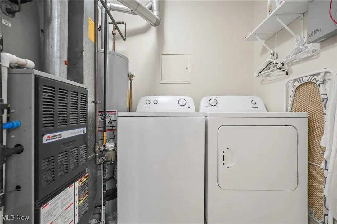Laundry area with heating unit, washer and clothes dryer, and gas water heater