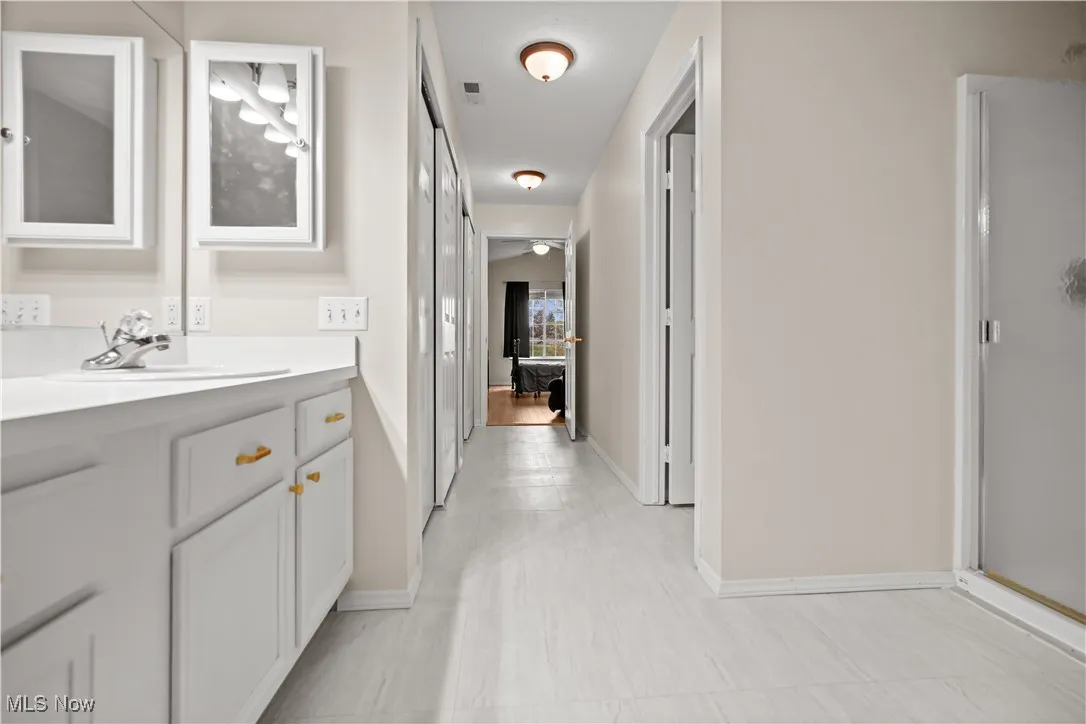 Full bath with vanity and a shower stall