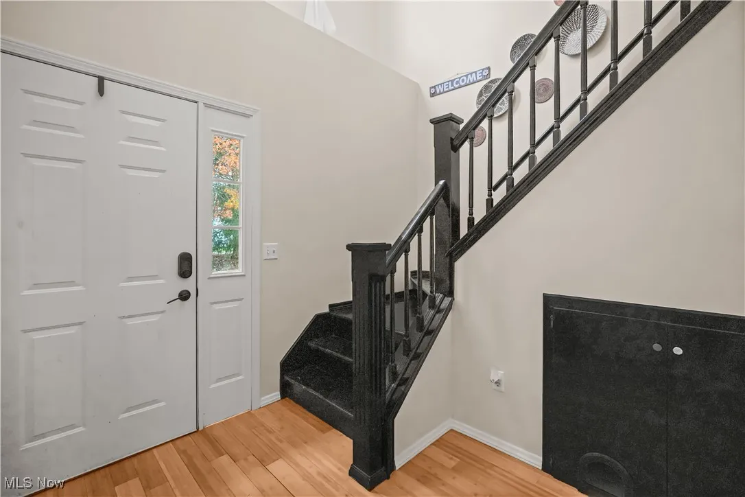 Entryway with light wood-style flooring and stairs