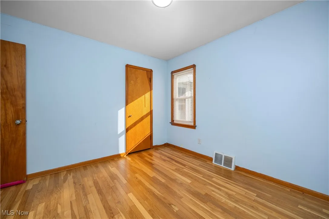 Empty room featuring light wood-style flooring and baseboards