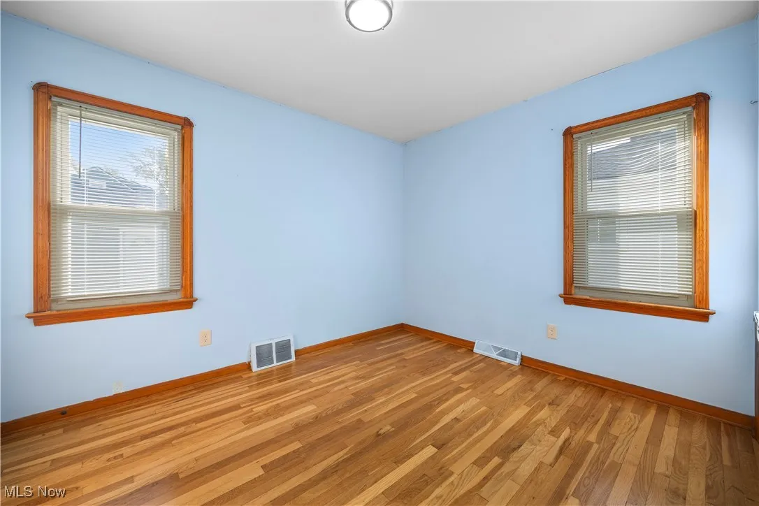 Empty room featuring light wood-type flooring and baseboards