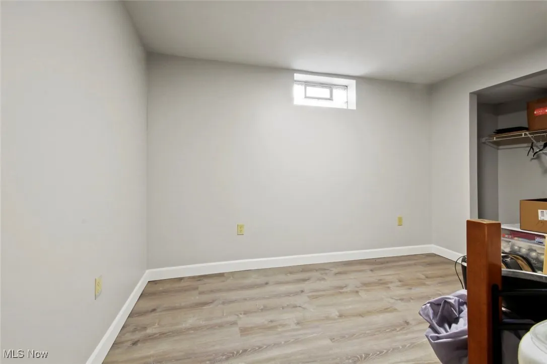 Bedroom with light wood finished floors and a closet