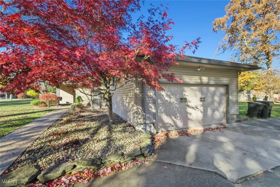 Garage featuring concrete driveway