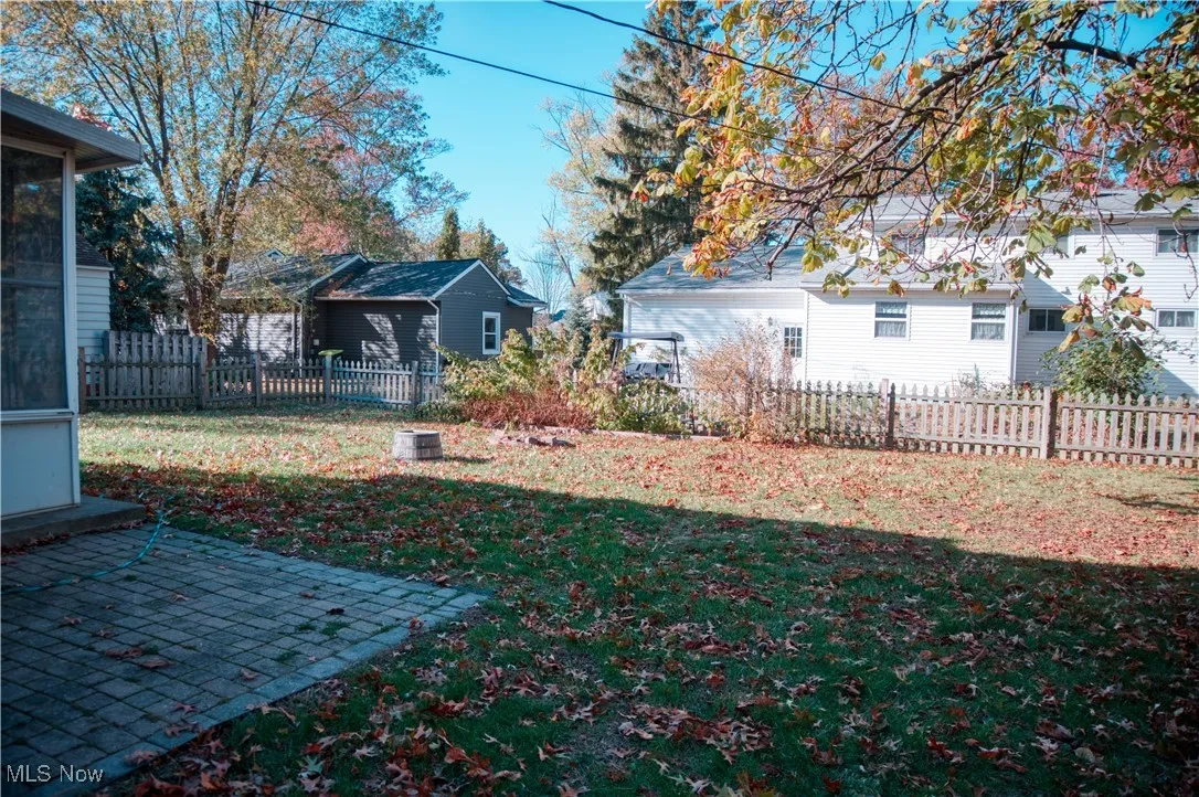 Fenced backyard featuring a patio area and a sunroom