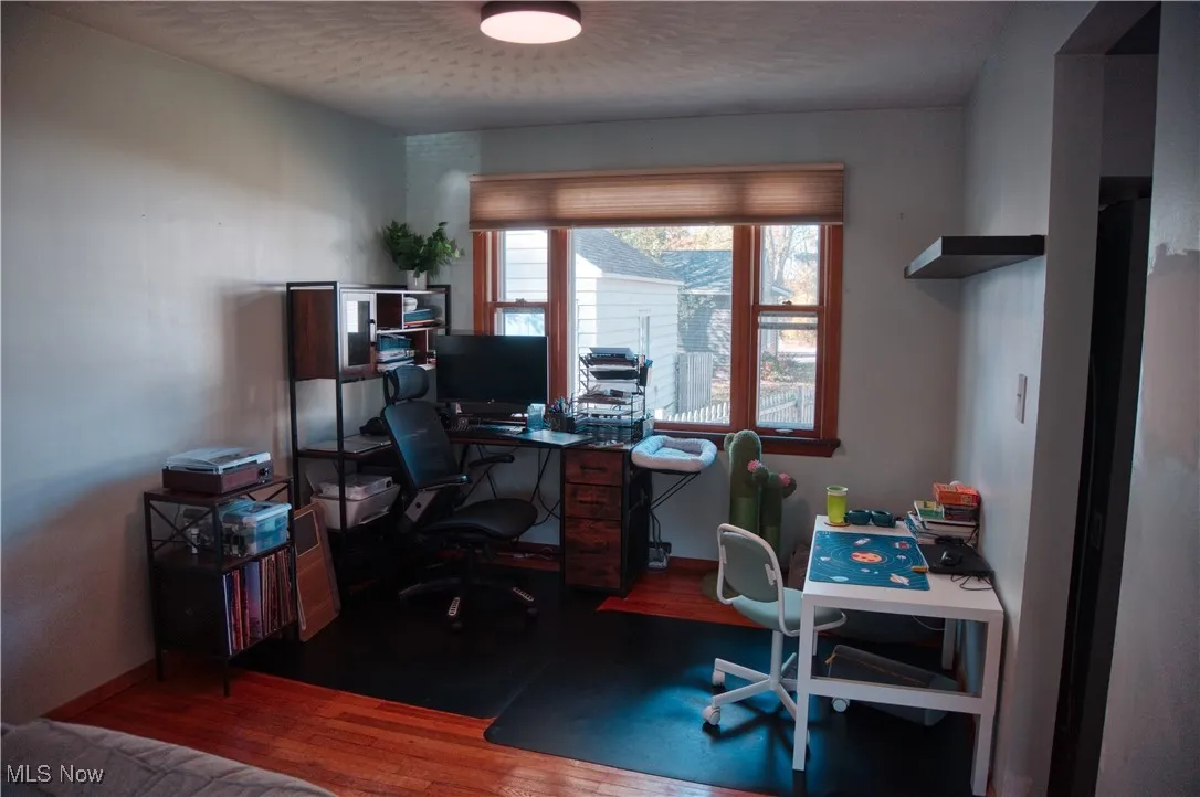 Home office with wood finished floors and baseboards