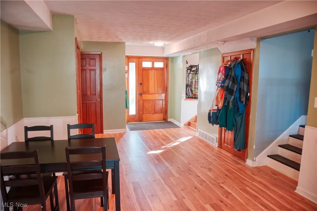 Foyer entrance with light wood finished floors and stairway