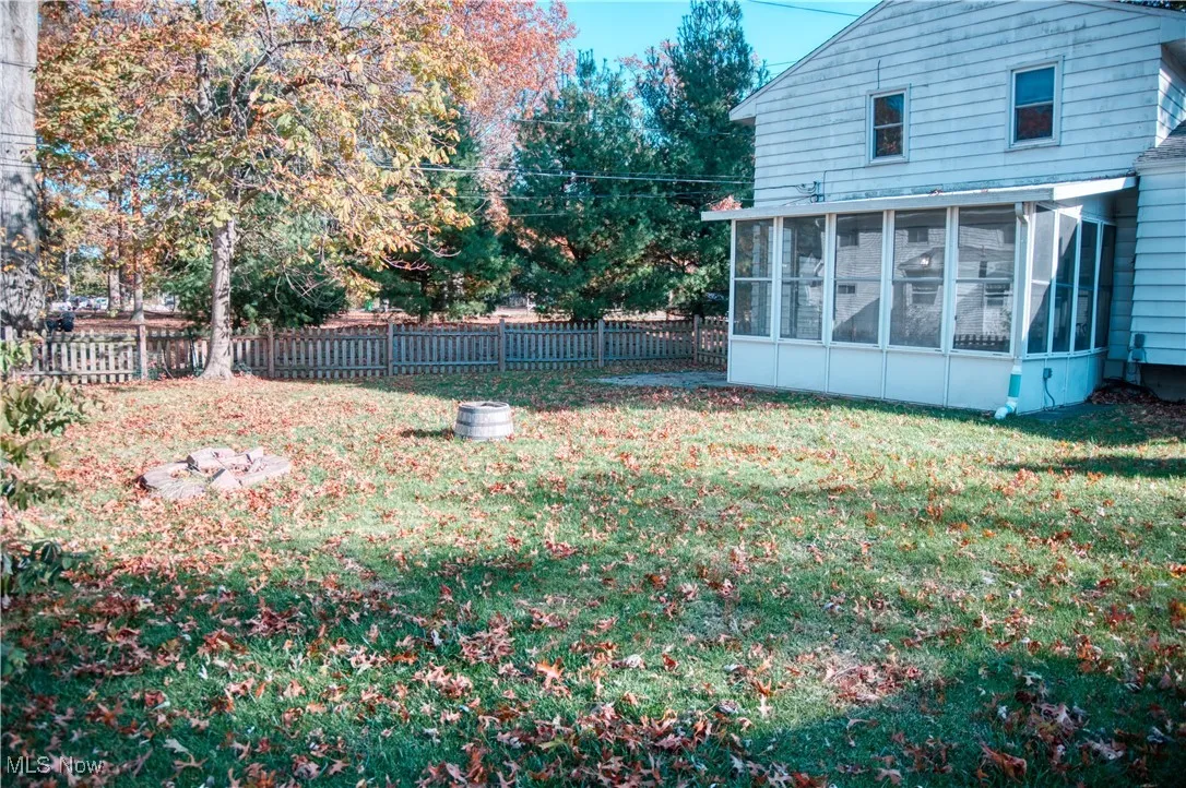 Fenced backyard with a sunroom
