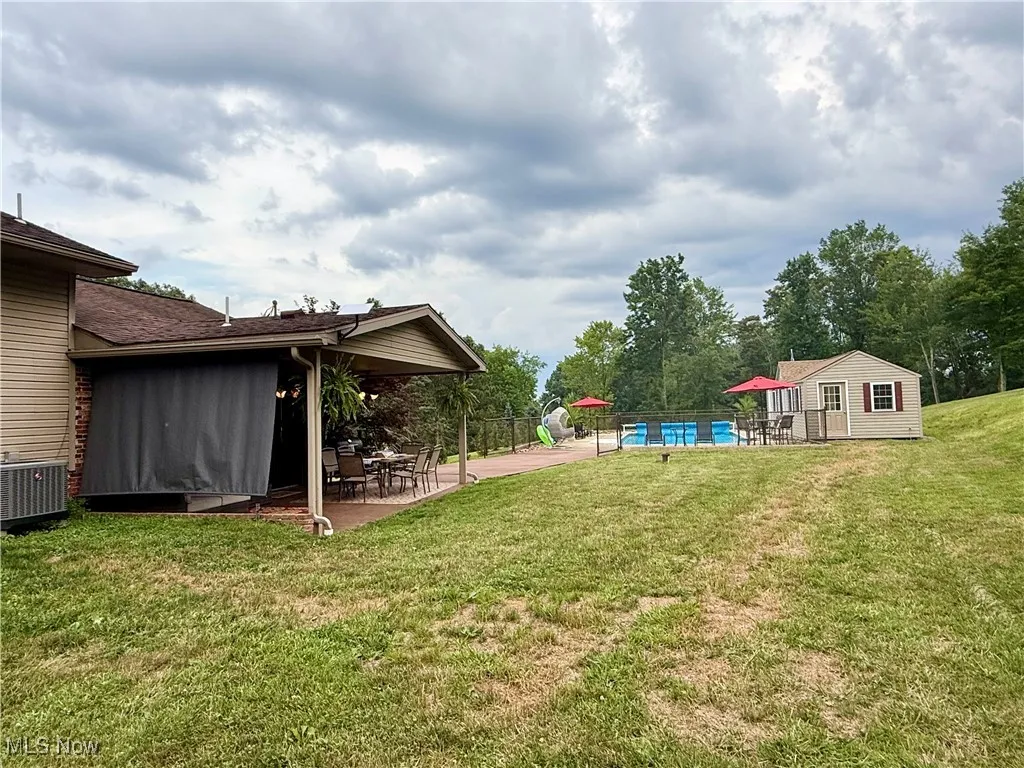 View of yard with a patio and an outdoor structure