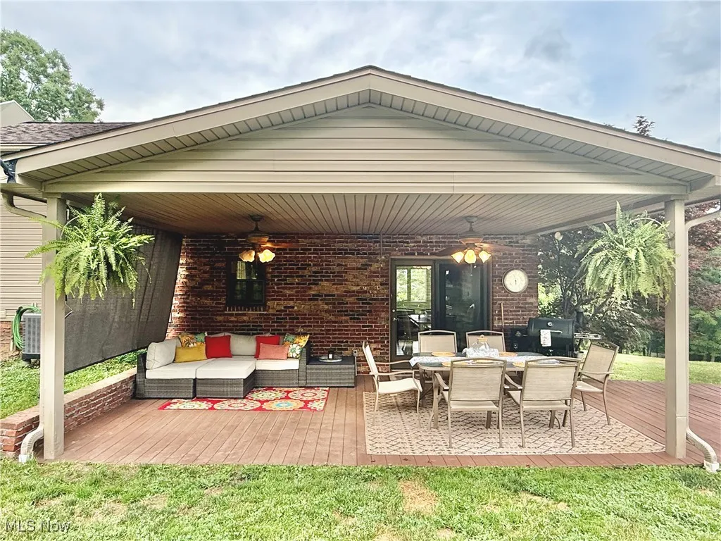 View of patio / terrace featuring a deck, an outdoor living space, ceiling fan, and outdoor dining area