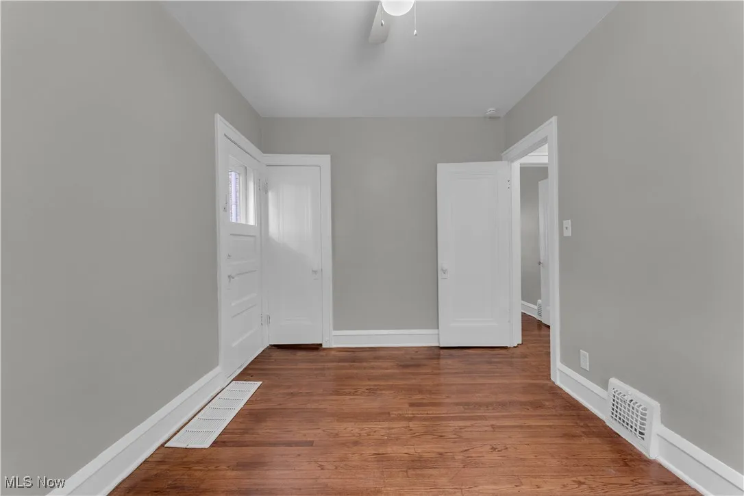 Empty room with wood finished floors and ceiling fan