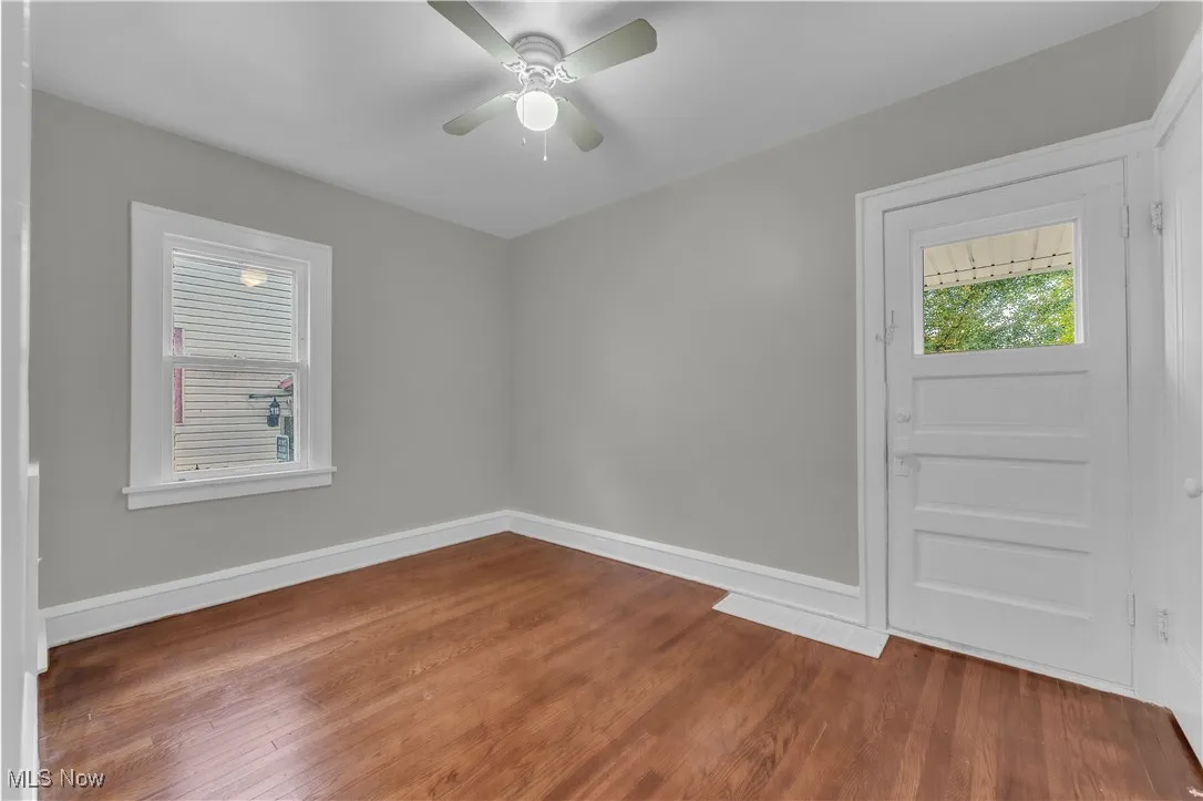 Empty room featuring wood finished floors and ceiling fan